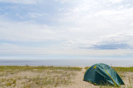 Tents on the sandy shore of the lake.の写真素材
