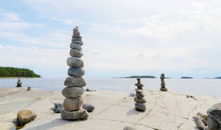 Stacked Rocks balancing, stacking with precision. Stone tower on the shore. Copy space.の写真素材
