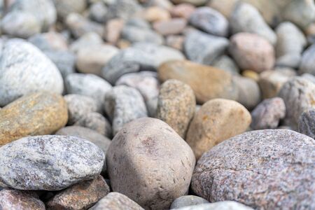 Pebbles on the shore. Round stones on the coast.の写真素材