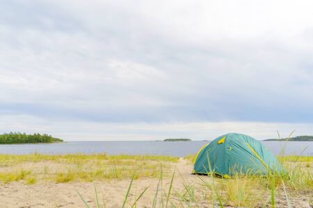 Tents on the sandy shore of the lake.の写真素材