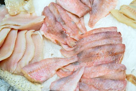 Fillet of fresh fish sea bass on an ice counter in a supermarket.の写真素材