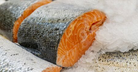 Salmon steak on counter ice in a supermarket.の写真素材