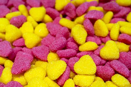 Pink and yellow heart shaped candies.の写真素材