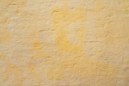 Yellow and beige paint on the wall of house. Construction and repair.の写真素材