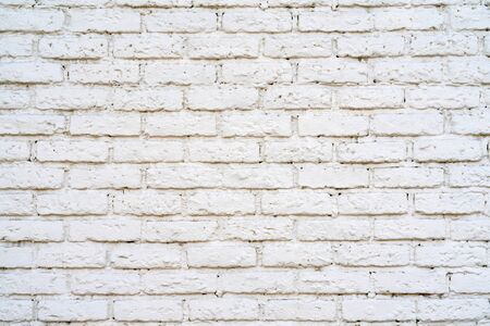 Brick wall is painted with white paint. Construction industry.の写真素材