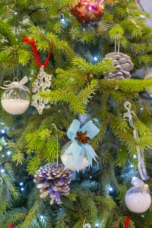 Christmas decorations on branches of green spruce. Christmas holiday.の写真素材