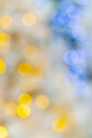 Yellow and blue christmas tree lights. Defocus. Background for design.の写真素材