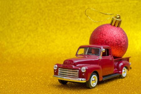 Toy car carries Christmas toy ball for holiday.の写真素材
