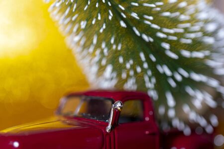 Toy car carries Christmas tree for holiday.の写真素材