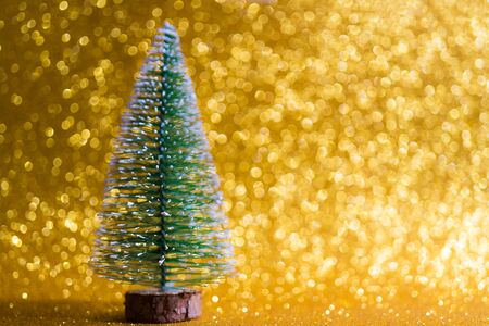 Green christmas tree on shiny background. Beautiful bokeh.の写真素材