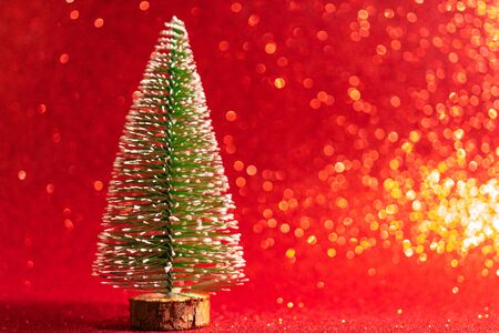 Green christmas tree on shiny background. Beautiful bokeh.の写真素材