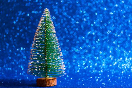 Green christmas tree on shiny background. Beautiful bokeh.の写真素材