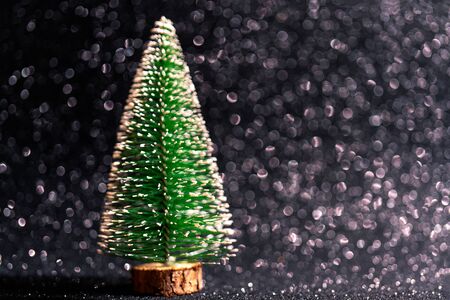Green christmas tree on shiny background. Beautiful bokeh.の写真素材