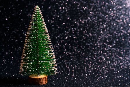 Green christmas tree on shiny background. Beautiful bokeh.の写真素材
