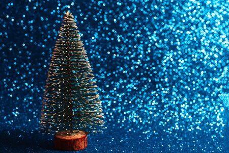 Green christmas tree on shiny background. Beautiful bokeh.の写真素材