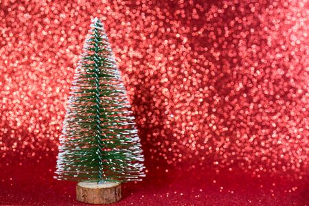 Green christmas tree on shiny background. Beautiful bokeh.の写真素材