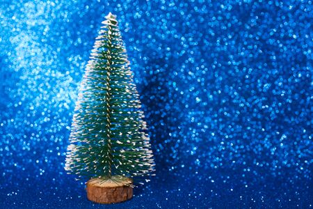 Green christmas tree on shiny background. Beautiful bokeh.の写真素材