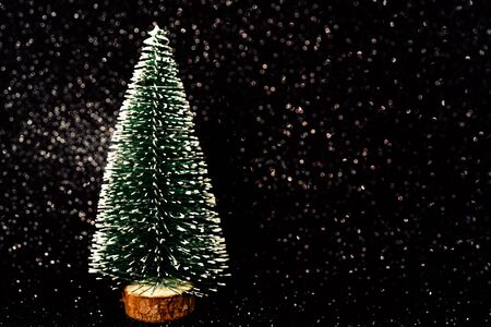 Green christmas tree on shiny background. Beautiful bokeh.の写真素材