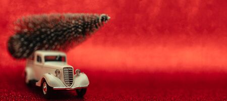 Toy car carries Christmas tree for holiday.の写真素材