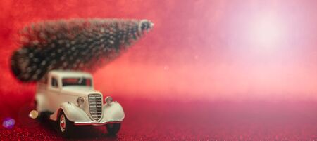 Toy car carries Christmas tree for holiday.の写真素材