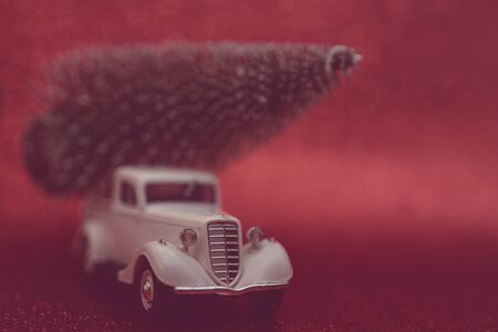 Toy car carries Christmas tree for holiday.の写真素材