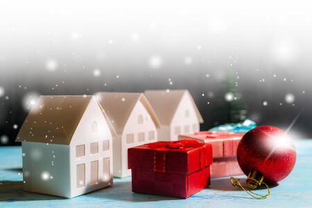 Christmas snowfall in small village. Christmas gift boxes.の写真素材