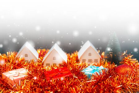 Christmas snowfall in small village. Christmas gift boxes.の写真素材