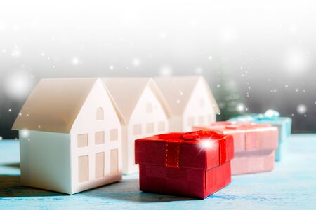 Christmas snowfall in small village. Christmas gift boxes.の写真素材