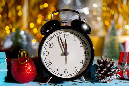 Christmas composition. Watches, gift boxes, cones and Christmas toys on shiny background. Copy space.の写真素材