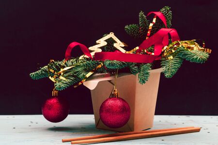 Christmas composition. Wok paper box. Christmas tree and decorations.の写真素材