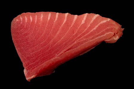 Tuna fillet on black background. Seafood cooking. Useful and tasty food.の写真素材