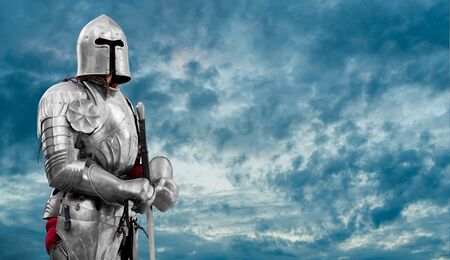 Knight in shiny metal armor. Reliable security and insurance. Copy space.