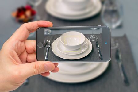 Table setting in restaurant. Smartphone in man's hand on transparent background. Photo smartphone.