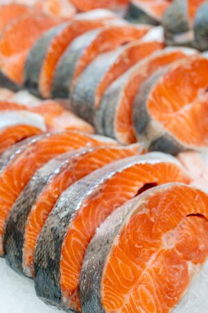 Fresh salmon steaks. Seafood is sold at store. Fresh fish at supermarket window.の写真素材