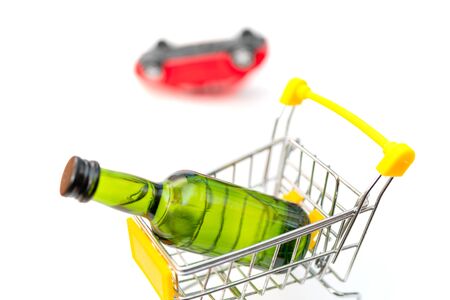 Selling alcohol in a store. Green bottle in a supermarket cart. Drink in a green bottle. Car accident.の写真素材