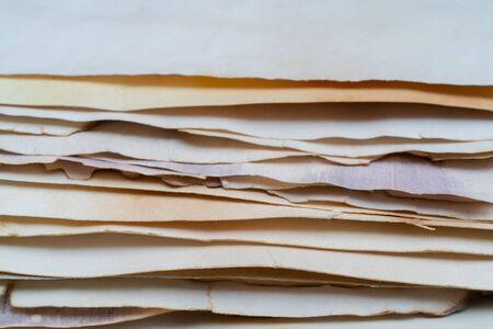 Stack of vintage paper. Old yellow sheets of paper. Yellow pages of the book.