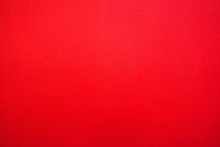 Abstract red background. Red stucco texture. Red rough surface.の写真素材