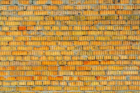 Yellow brick building wall. Interior of a modern loft. Background for design and interview recording.の写真素材