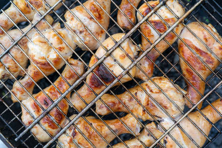 BBQ chicken legs. Cooking meat outdoors. Cooking process.