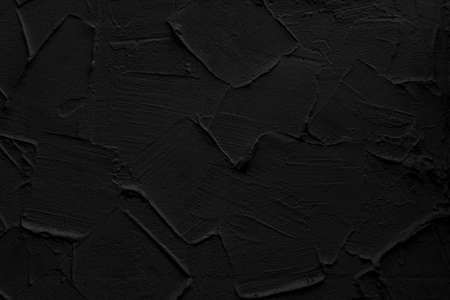 Black wall of the building. Rough plaster surface. Abstract background.の写真素材