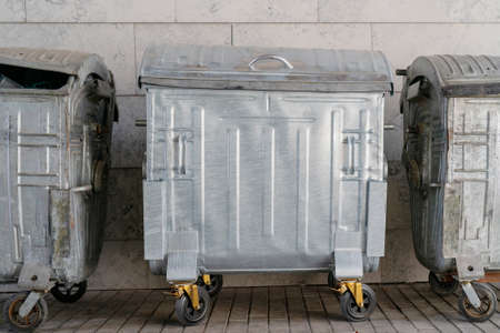 Metal trash can on wheels. Garbage collection in the city.の写真素材