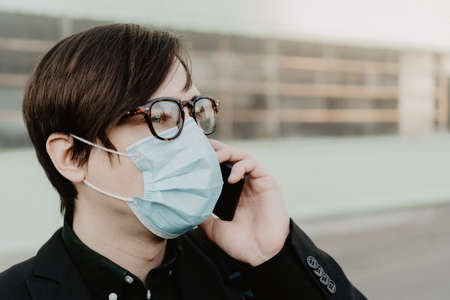 White young man holds a smartphone in his hand. Selective focus.の写真素材