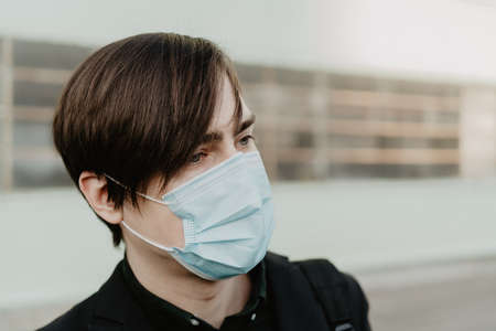 White young man holds a smartphone in his hand. Selective focus.の写真素材