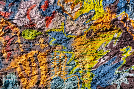 Multicolored paint on a rough wall. Abstract illustration on stucco.の写真素材