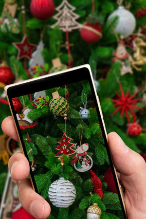 This green beautiful Christmas tree on the smartphone screen.の写真素材
