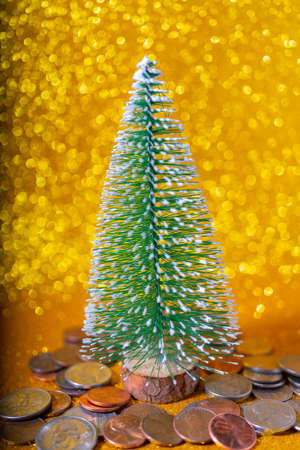 Christmas tree and Metallic American cents. Storage and accumulation of money in the financial system of banks and loans.の写真素材