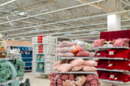 Blurred supermarket background. Sale of pillows and linen in a supermarket.の写真素材
