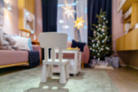 Blurred Christmas background in the room. Christmas tree in the interior of the apartment.の写真素材