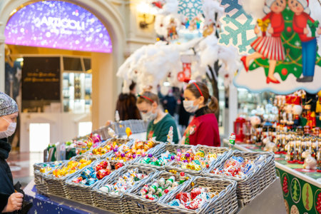 Moscow, Russia. December 08.2020. Selling Christmas decorations in a supermarket. Vendors in medical masks.のeditorial素材