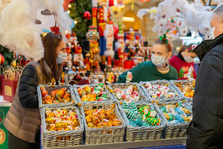 Moscow, Russia. December 08.2020. Selling Christmas decorations in a supermarket. Vendors in medical masks.のeditorial素材